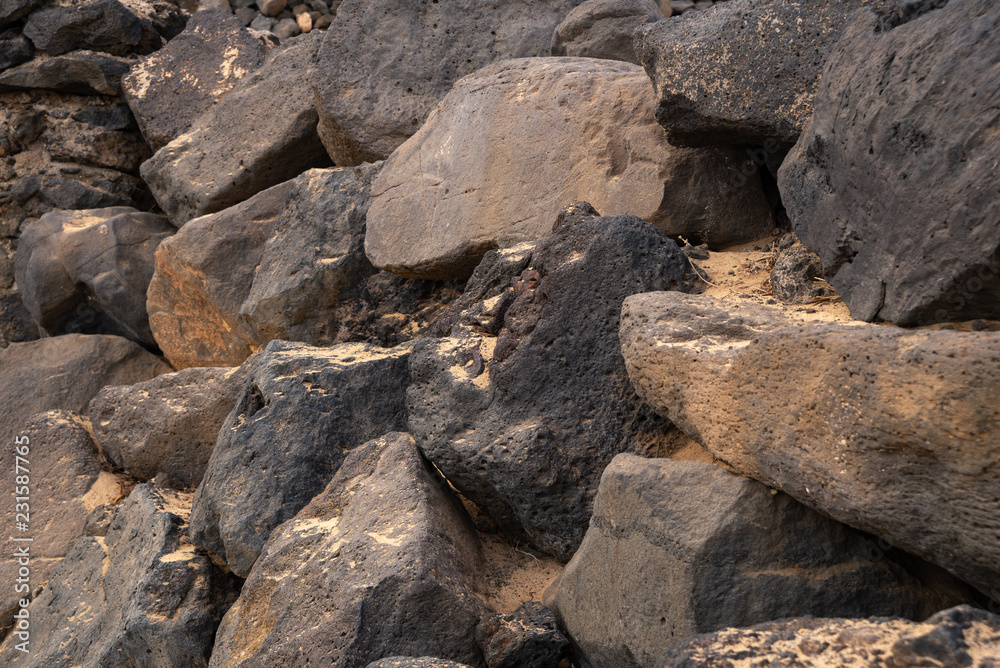 a fragment of a wall assembled from simple gray uneven stones