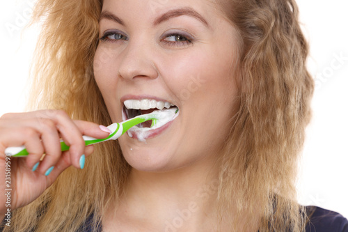 Woman brushing cleaning teeth