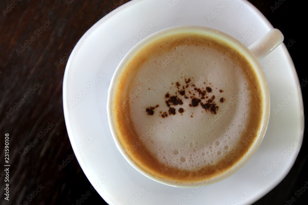 hot cappuccino coffee on wooden table hot cappuccino coffee on wooden table