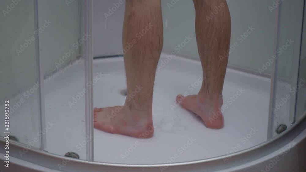 Stock Feet of a child in the shower. Young teen boy bathing under a shower at home. | Adobe Stock