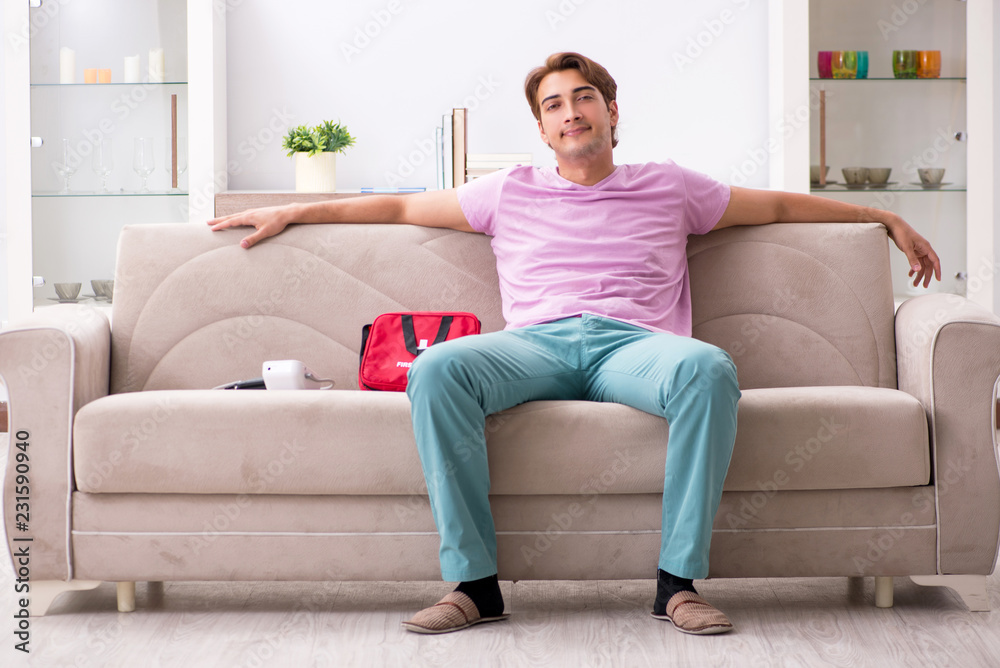 Sick man at home with first aid kit Sick man at home with first aid kit