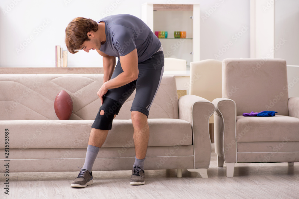 Injured man recovering at home from sports injury Injured man recovering at home from sports injury