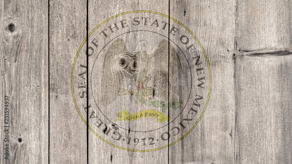 USA Politics News Concept: US State New Mexico Seal Wooden Fence Background