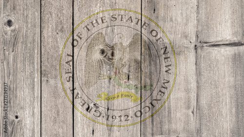 USA Politics News Concept: US State New Mexico Seal Wooden Fence Background