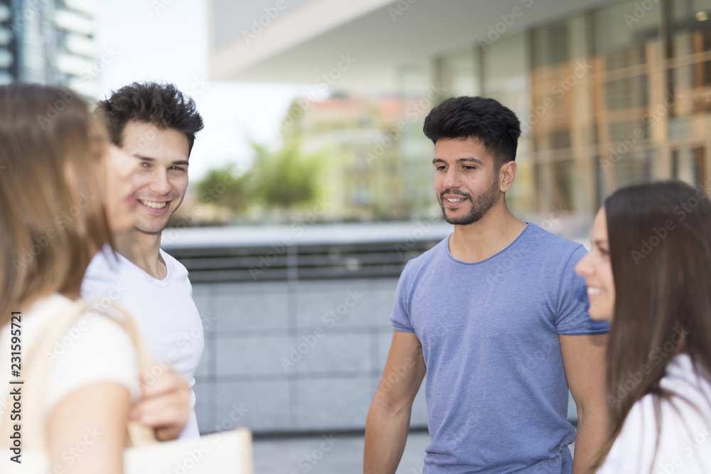 Group of young friends speaking outdoor Group of young friends speaking outdoor