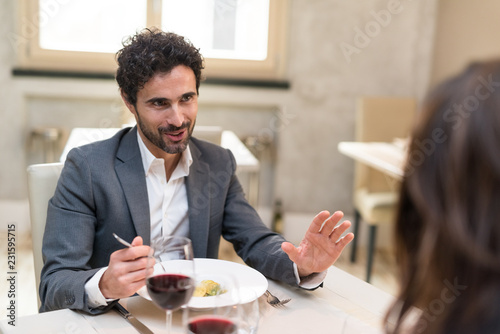 Man speaking while eating at the restaurant