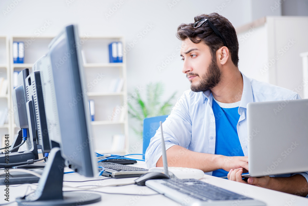 IT technician looking at IT equipment