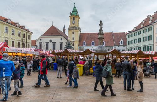 View on Christmas market on the Main square in Bratislava,Slovakia. Stara radnica and Bratislava Christmas Market, blurred people can be seen.