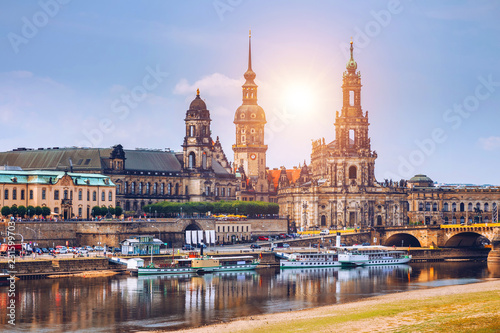 Incredible evening panorama of Cathedral of the Holy Trinity or Hofkirche, Bruehl's Terrace or The Balcony of Europe. Dramatic autumn sunset on Elbe river in Dresden, Saxony, Germany, Europe. © daliu