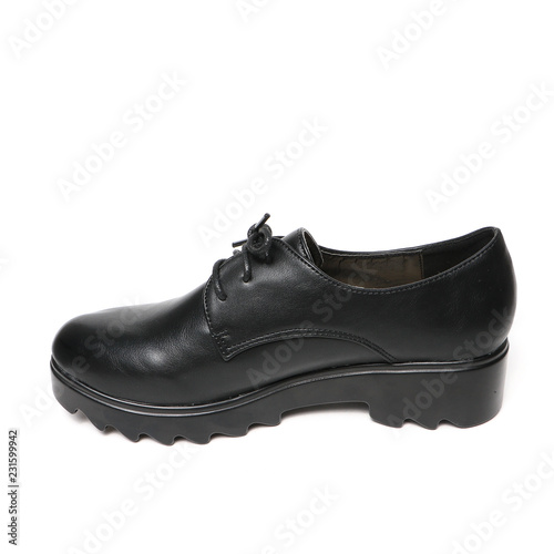 Women's platform black shoes isolated on white background © GreenStock