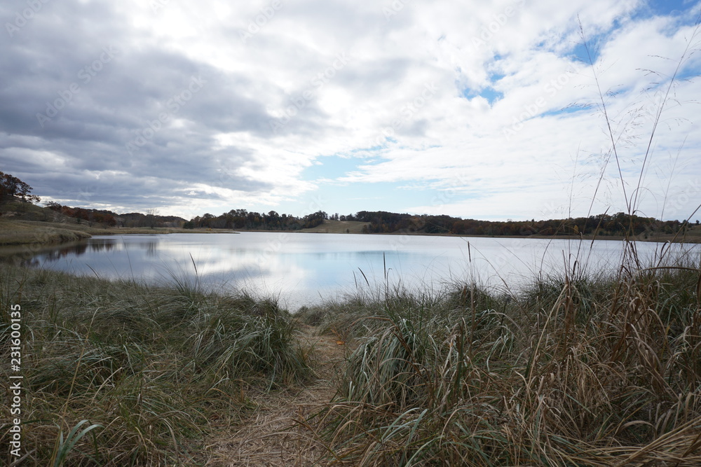 Fall landscape in the Midwest with lake, clouds, and beach grass