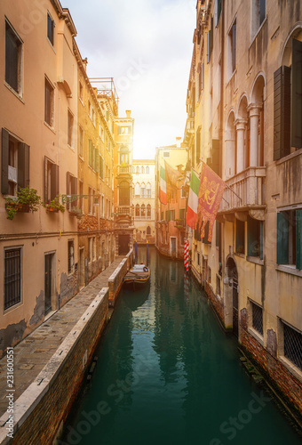 View of the street canal in Venice, Italy. Colorful facades of old Venice houses. Venice is a popular tourist destination of Europe. Venice, Italy. #231600551