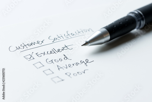 Business hand evaluate excellent on customer satisfaction form