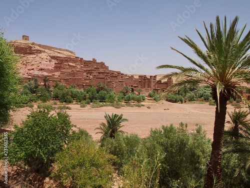 Kasbah Ait Benhaddou (Ksar of Ait-Ben-Haddou) the door to the Sahara Desert in Morocco behind palm trees, UNESCO World Heritage
