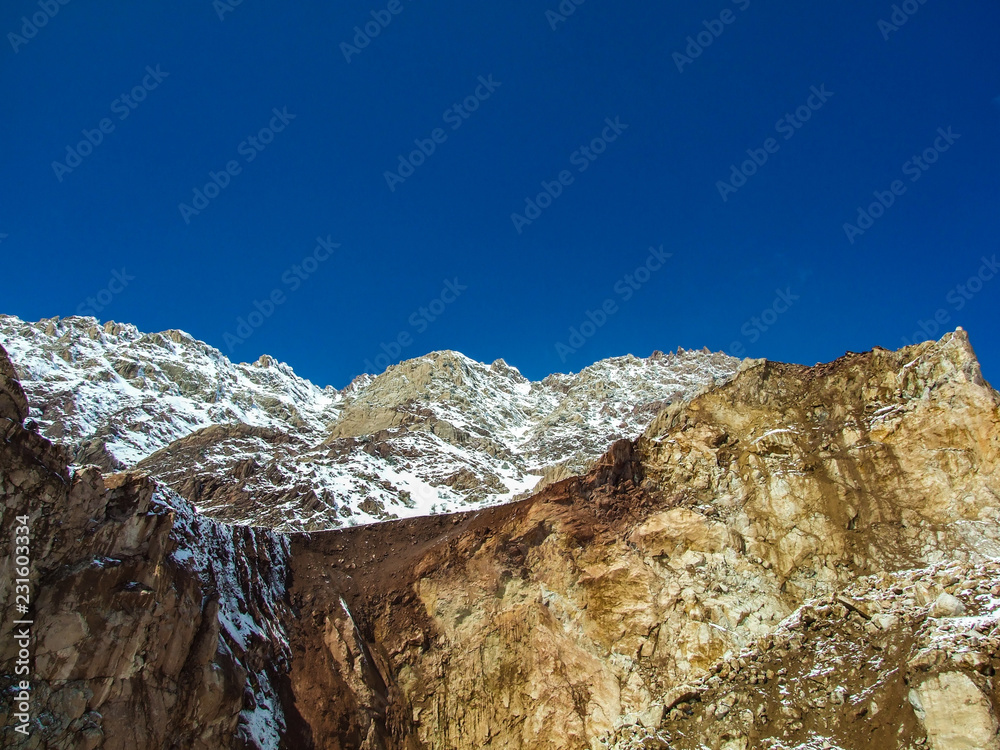 The view of snowy mountains and peak with blue sky