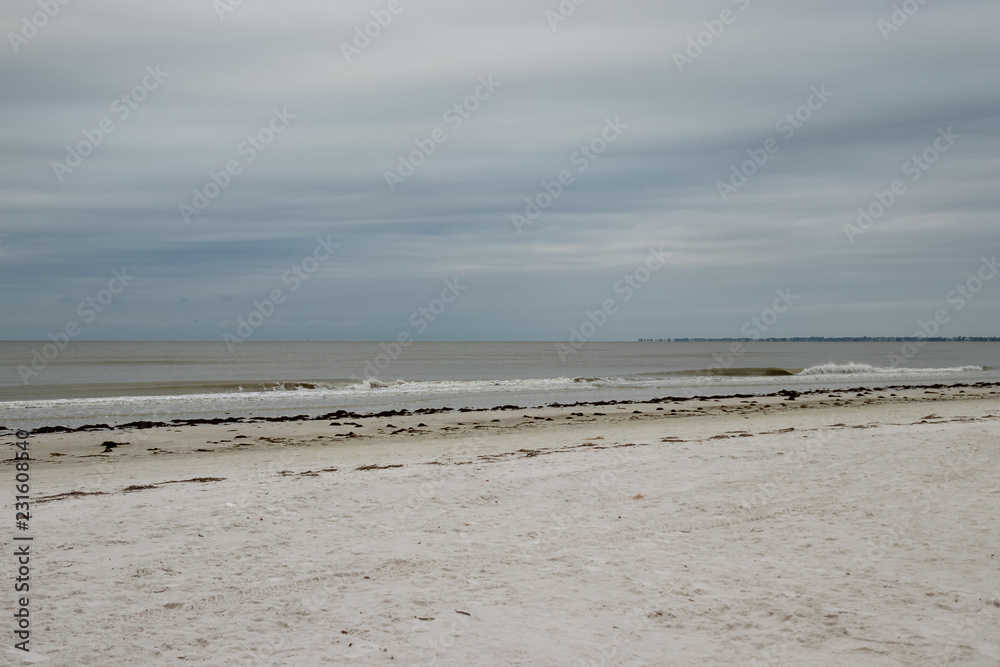 View of Fort Myers beach on Estero Island in Florida on stormy morning.