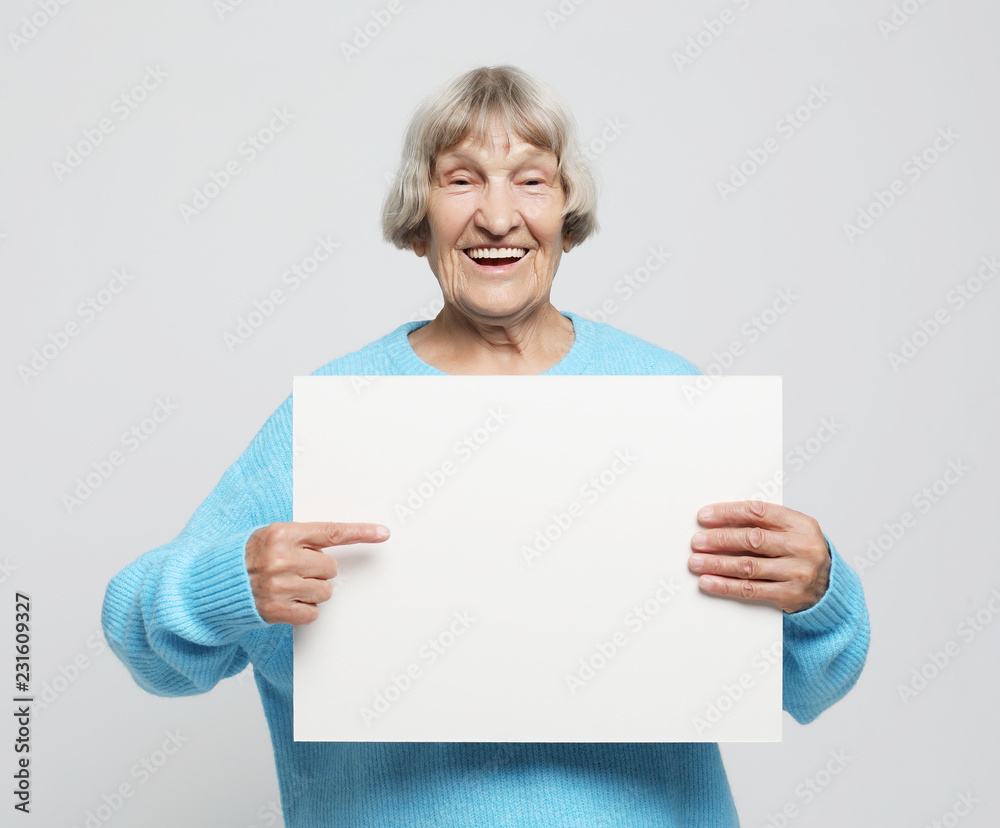 Aged woman with blank advertising board or copy space. Aged woman with blank advertising board or copy space.