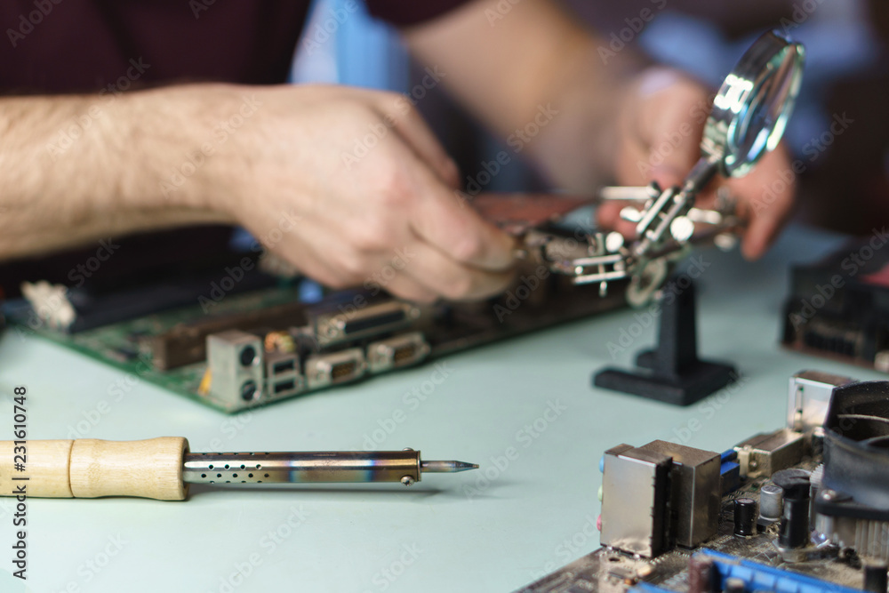 Repair motherboard. Man repairing motherboard. Workflow and desktop professional. Close-ups Repair motherboard. Man repairing motherboard. Workflow and desktop professional. Close-ups
