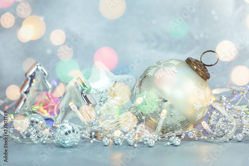 christmas frosty background with fir tree decorative balls and toys, lights and beads