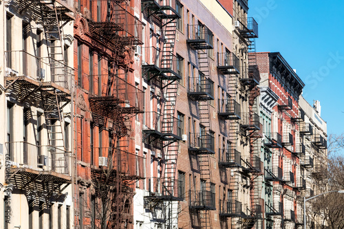 Repeating pattern of fire escapes on colorful old buildings along St. Marks Place in New York City photo