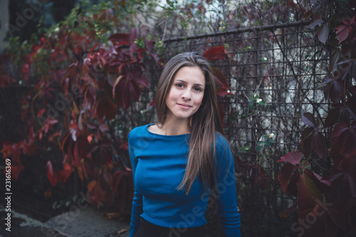 Slika na platnu Girl in a blue long sleeve shirt on a street. Atumn time.