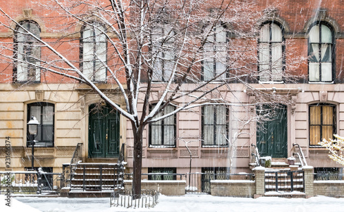 Winter scene with snow covered sidewalks along Stuyvesant Street in the East Village neighborhood of New York City photo