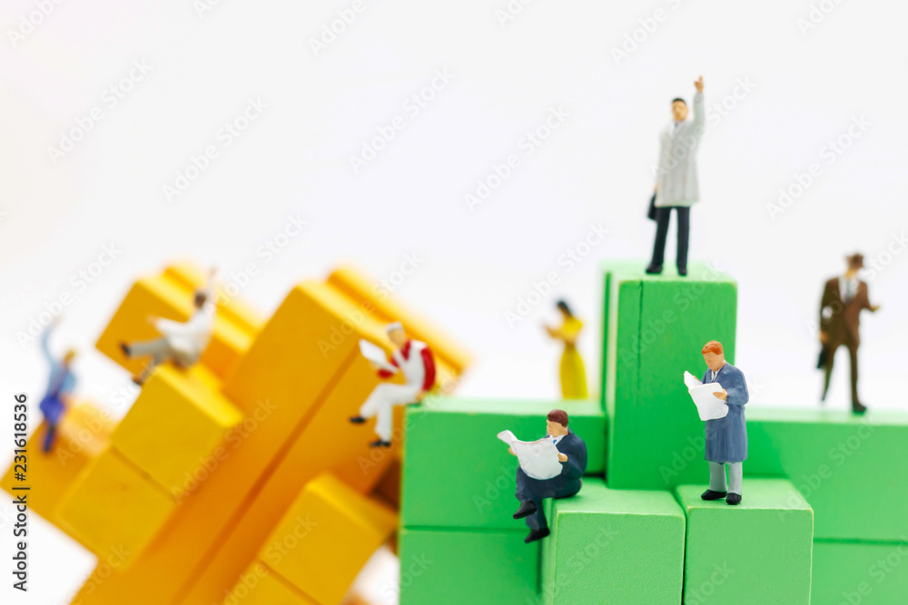 Miniature business people sitting on wood block , recruitment finding employee and business concept.