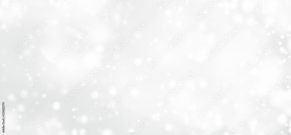 Silver  abstract bokeh background with snowflake and white glittering bokeh stars. A shiny holiday card. Glowing blurred lights.