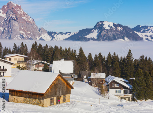 Village of Stoos in the Swiss canton of Schwyz in winter, the Grosser Mythen summit in the background