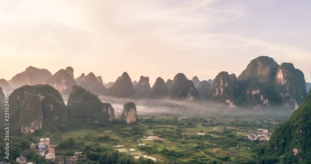 Breathtaking aerial establishing shot over beautiful limestone karst mountain scenery, covered with haze at sunset in,Yangshuo County,China.Mountain landscape top view