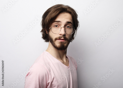 Headshot of satisfied cheerful man wearing glasses, glad to find suitable well paid job