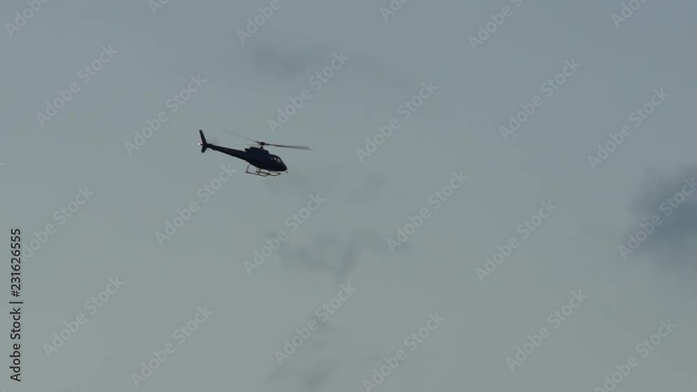 silhouette of a helicopter flying in a cloudy sky in the evening silhouette of a helicopter flying in a cloudy sky in the evening
