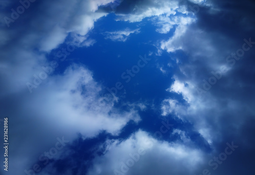 Dramatic gap in white clouds background