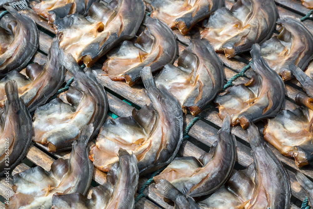 Fototapeta premium Dried fish on a bamboo panel.