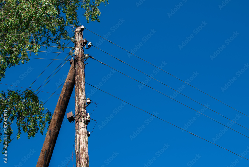 Old power line on a wooden pole. Transmission of electricity by wire in  rural areas. Breakdown on high-voltage line and transformer. The telegraph  pole. Stock Photo | Adobe Stock