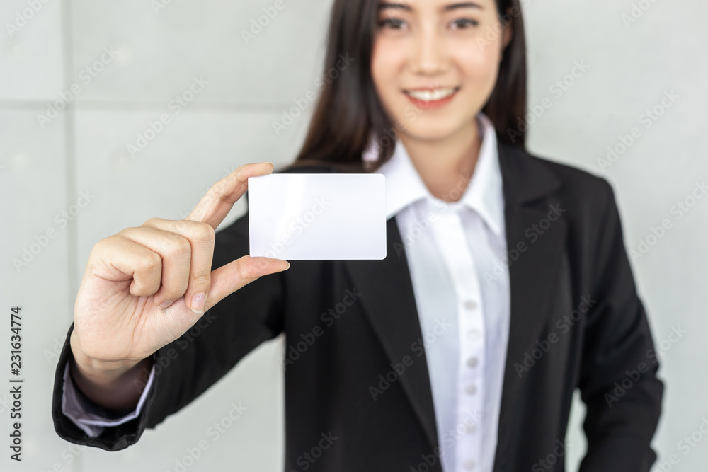 business woman holding and showing empty business card or name card - business concept business woman holding and showing empty business card or name card - business concept