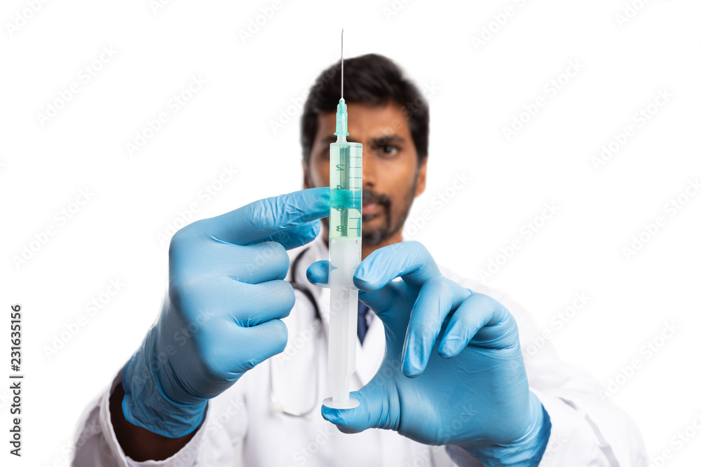 Medic checking syringe with vaccine. Medic checking syringe with vaccine.