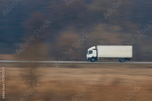 Truck going fast on a suburban road photo