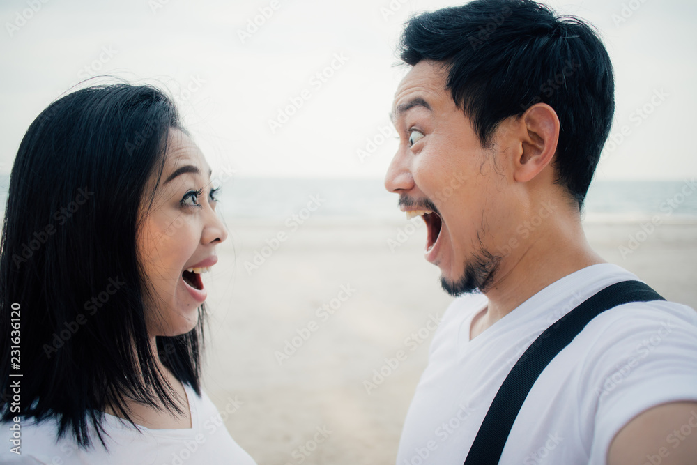 Wow face of couple tourist on romantic beach vacation trip. Wow face of couple tourist on romantic beach vacation trip.