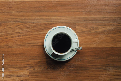 Coffee cup on the wooden floor in the morning.