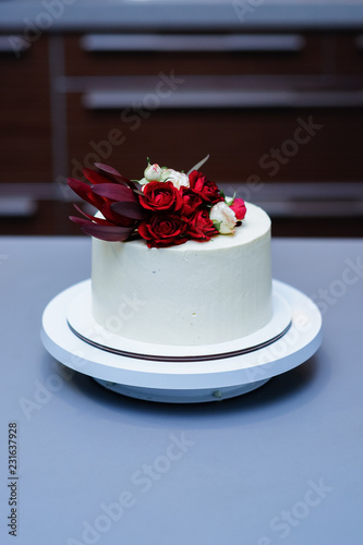 Decorated by flowers white naked cake, rustic style for weddings