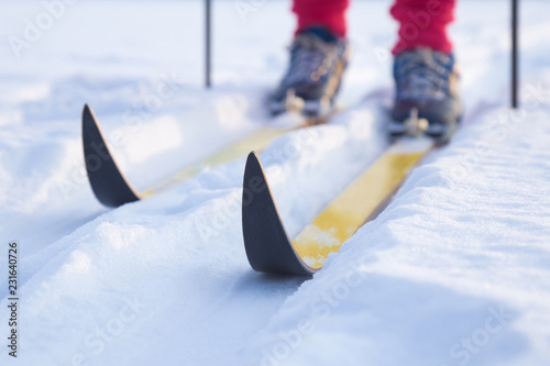 Ski on track in the fresh, white snow in winter day. Classic cross country skiing. Active lifestyle. Enjoying sport. Closeup. photo