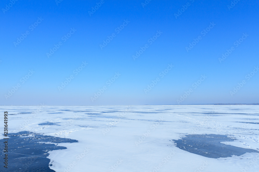 Winter landscape with sea and blue sky