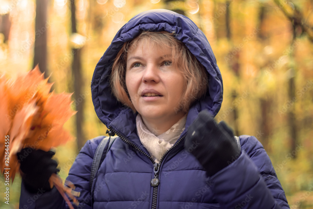 Bouquet of autumn red and orange maple leaves in woman hand Bouquet of autumn red and orange maple leaves in woman hand
