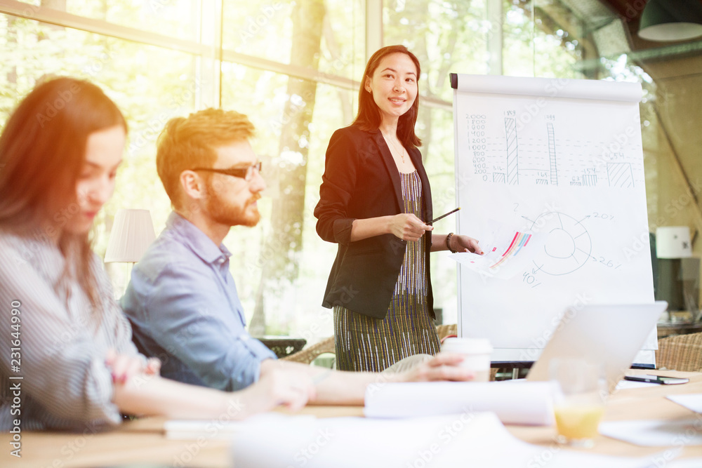 Woman works with business ideas on a background of graphs. Woman works with business ideas on a background of graphs.