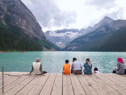 Lake Lousie - People sitting on the Water with the mountian background
