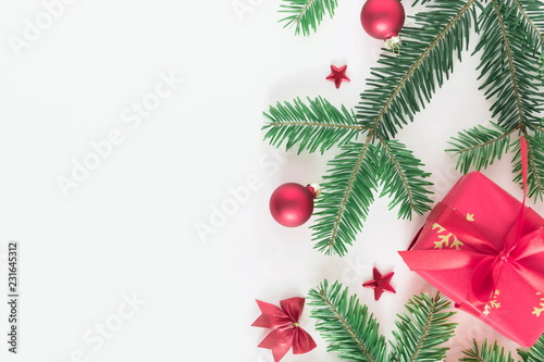 Christmas elegant composition. Xmas red gifts and decorations  green fir tree branches on white background. Christmas  New Year  winter concept. Flat lay  top view  copy space 