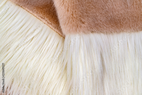 Soft faux fur texture macro. winter white fur jackets fashion background, close up detail. 