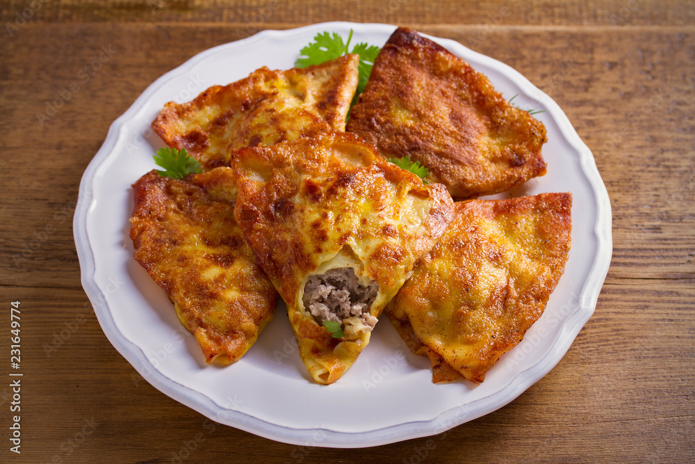 Savor crepes with meat filling. Crepes stuffed with beef sausage. horizontal Savor crepes with meat filling. Crepes stuffed with beef sausage. horizontal