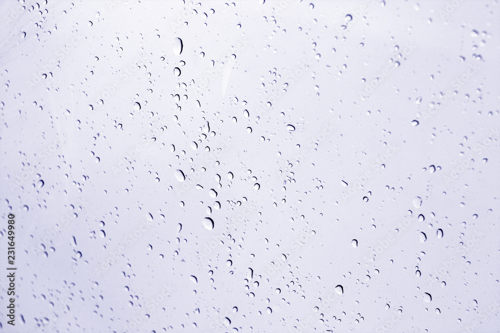 Blured water drops on window in blue tone. Blured water drops on window in blue tone.